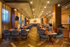 a restaurant with tables and chairs in a room at Four Points by Sheraton Chennai OMR in Chennai