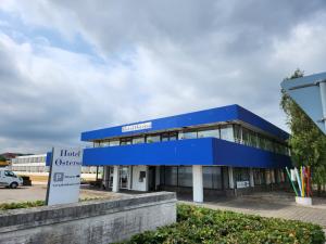 a blue building with a sign in front of it at Hotel Østersø in Aabenraa