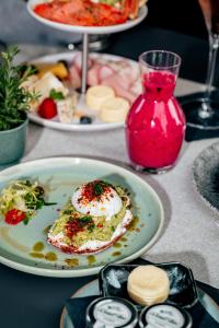 einen Tisch mit einem Teller Essen auf dem Tisch in der Unterkunft DO & CO Hotel München in München