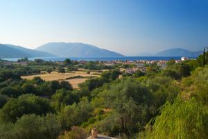 a view of a town with mountains in the background at Maria's Apartments in Sami