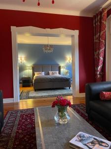 a bedroom with a bed and a vase of flowers at Villa Klara Cieplice in Jelenia Góra