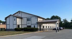 a large white building with a parking lot at FairBridge Inn Express Chesterton in Chesterton