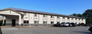 a large white building with cars parked in a parking lot at FairBridge Inn Express Chesterton in Chesterton