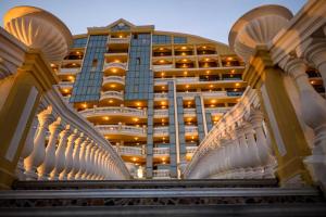 a building with a staircase in front of a building at Imperial Palace Hotel in Sunny Beach