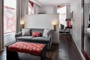 a living room with a couch and a red stool at Fairfield Inn & Suites by Marriott Washington Downtown in Washington