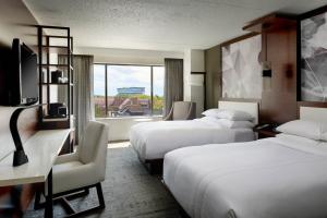 A bed or beds in a room at Marriott East Lansing at University Place