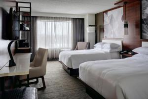 A bed or beds in a room at Marriott East Lansing at University Place