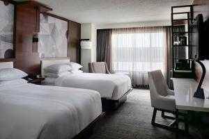 A bed or beds in a room at Marriott East Lansing at University Place