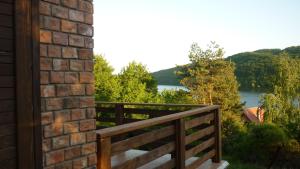 a balcony with a fence and a view of a lake at Chata pri Vode in Kelča