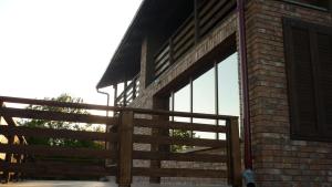 a building with a wooden fence and a window at Chata pri Vode in Kelča