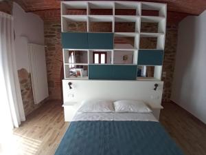 1 dormitorio con 1 cama con estanterías azules y blancas en Podere Feltrino, en Grosseto