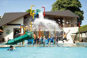 a group of people playing in the water at a water park at Bali Dynasty Resort in Kuta