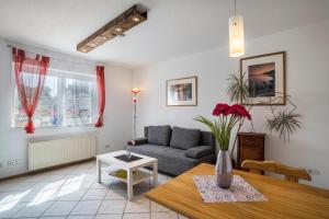 a living room with a couch and a table at Ferienwohnung Schläfer in Kappel-Grafenhausen