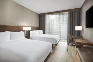 A bed or beds in a room at AC Hotel by Marriott Lansing University Area