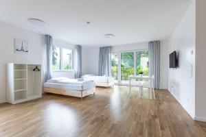 A bed or beds in a room at T&K Apartments - Bergisch Gladbach - 3 Comfortable Apartments - 18 min to Fair Messe Cologne