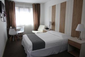 Postel nebo postele na pokoji v ubytování Hotel Tierrasur