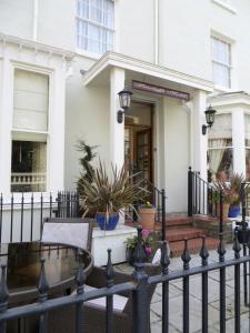 a black fence in front of a white house at Seaclyffe Hotel Ltd in Llandudno