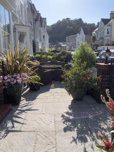 a patio with potted plants on a house at Seaclyffe Hotel Ltd in Llandudno