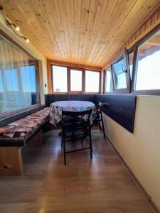 a room with a table and chairs and windows at Guest House Italia in Kavarna