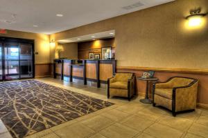 a lobby with two chairs and a bar at Hampton Inn & Suites Kalamazoo-Oshtemo in Oshtemo