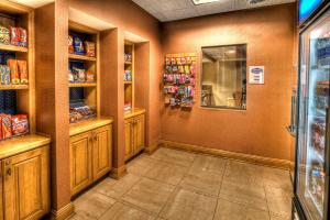 a grocery store aisle with wooden cabinets and shelves at Hampton Inn & Suites Kalamazoo-Oshtemo in Oshtemo