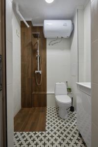 a small bathroom with a toilet and a shower at LAZUR ~ 2BD Flat next to the Sea Garden in Burgas City