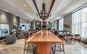 a large dining room with a large wooden table and chairs at Hampton Inn Sydney in Sydney