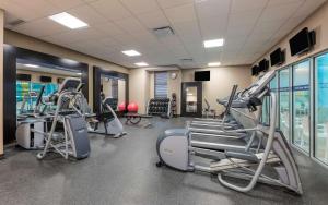 a gym with treadmills and cardio equipment in a building at Hampton Inn Sydney in Sydney