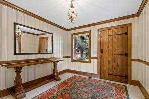 a room with a mirror and a wooden door at White River Mountain Manor- Million dollar view in Eureka Springs