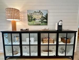 a black cabinet with a lamp on top of it at Glass Cabin in Eureka Springs