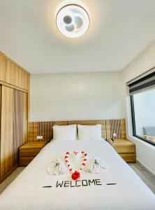 a bedroom with a bed with a welcome sign on it at Sunflower Hotel & Resort in Bao Loc