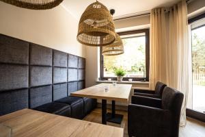 - une salle à manger avec une table et des chaises dans l'établissement Hotel i Restauracja Czarny Kos, à Borkowo