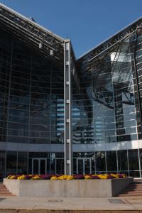 a large glass building with flowers in front of it at DoubleTree by Hilton Hotel South Bend in South Bend