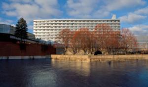 a large building in front of a body of water at DoubleTree by Hilton Hotel South Bend in South Bend