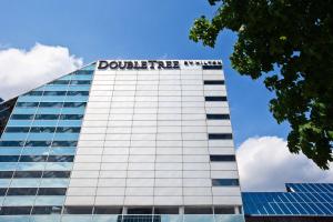 a tall glass building with the dolittle building at DoubleTree by Hilton Hotel South Bend in South Bend