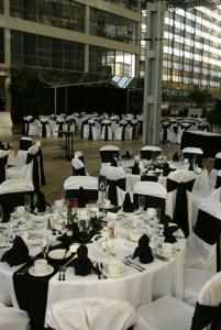 a large group of tables with white tablecloths at DoubleTree by Hilton Hotel South Bend in South Bend