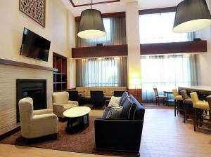 - un hall avec des canapés, des chaises et une cheminée dans l'établissement Hampton Inn & Suites Laval, à Laval