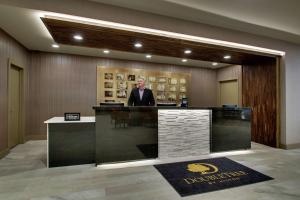 a man standing at a bar in a lobby at Doubletree By Hilton Mt. Vernon in Mount Vernon