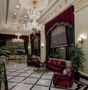 a living room with purple furniture and a chandelier at DoubleTree By Hilton Gaziantep in Gaziantep