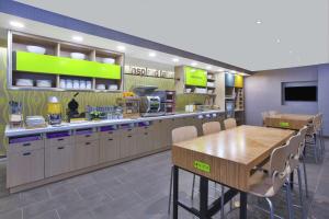 a fast food restaurant with a table and chairs at Home2 Suites By Hilton Holland in Holland