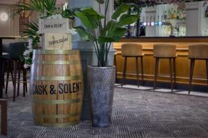 two vases with plants in them sitting on a table at DoubleTree by Hilton Southampton in Southampton