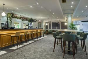 a bar with a row of stools in a restaurant at DoubleTree by Hilton Southampton in Southampton