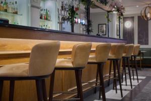 a row of chairs lined up at a bar at DoubleTree by Hilton Southampton in Southampton