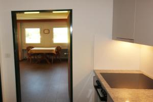 a kitchen with a table and a dining room at Residenza Lagrev 1 Zimmerwohnung Nr 228 - Typ 11A - 2 Etage - Ost in Sils Maria