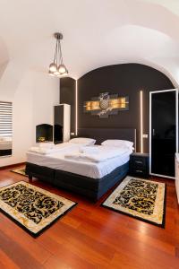 a bedroom with a large bed with a large headboard at Demiani House in Sibiu