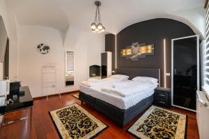 a bedroom with a large bed with a black headboard at Demiani House in Sibiu