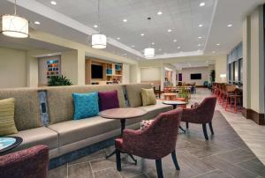 una hall con divano, tavoli e sedie di Home2 Suites by Hilton Houston Medical Center, TX a Houston