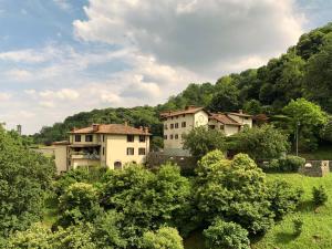 eine Gruppe von Häusern auf einem Feld mit Bäumen in der Unterkunft La Valletta Relais in Bergamo