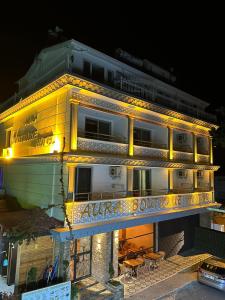 un grand bâtiment avec des lumières sur son côté dans l'établissement Aura Boutique Hotel, à Sidé