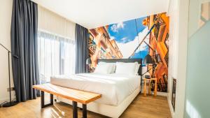 a hotel room with a bed and a mural at Hills Hotel Lisboa in Lisbon